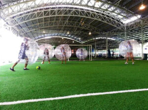 Comparison of land and water zorbing experiences in Singapore, showcasing the unique thrills of each